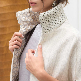 Close-up of a person wearing a smocked neck with a wooden background