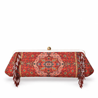 Tapestry Red Le Long, a long red rug-pattern clutch with beaded fringes on each side