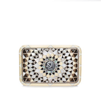 A clutch handbag with a geometric pattern featuring a mother-of-pearl inlay, gold detailing, and an al salam design in the center.